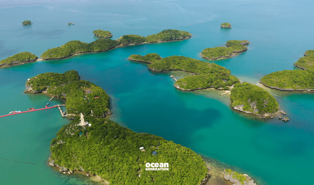 Island communities depend on the Ocean for their livelihoods. Image shows a scattering of islands in the Ocean with lush green trees and blue water/