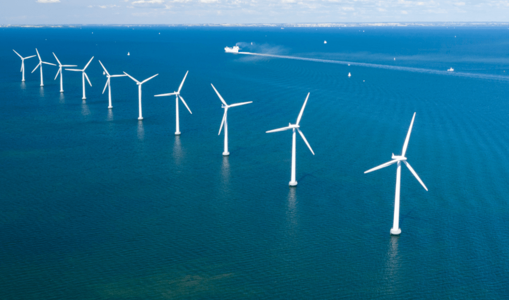 A row of bottom fixed wind farms in the Ocean.