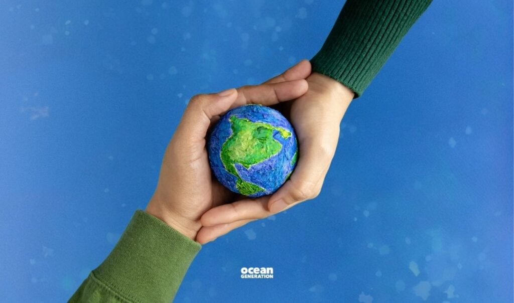 Two hands holding up a replica of the planet, symbolising that to take climate action change is needed from everyone, everywhere. No sector can escape the need for transformation. And everyone must look after our planet. The planet is in our hands.
